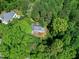 An aerial view of the house surrounded by lush trees, gray roof, and well-kept lawn at 2901 Hunters Bluff Dr, Raleigh, NC 27606