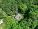 An aerial view of the house surrounded by lush trees, gray roof, and well-kept lawn at 2901 Hunters Bluff Dr, Raleigh, NC 27606