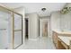Bathroom featuring a shower, vanity with sink, and doorway leading to carpeted room and staircase at 2901 Hunters Bluff Dr, Raleigh, NC 27606