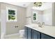 Bathroom featuring dark blue vanity, toilet, shower and large garden window providing plenty of natural light at 2901 Hunters Bluff Dr, Raleigh, NC 27606
