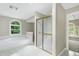 Bright bathroom with shower, soaking tub, and window providing ample natural light and adjacent room access at 2901 Hunters Bluff Dr, Raleigh, NC 27606