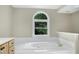 Bright bathroom featuring large soaking tub with garden window providing a view to lush greenery outside at 2901 Hunters Bluff Dr, Raleigh, NC 27606