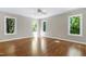 Spacious bedroom featuring three large windows that offer a great view and a ceiling fan at 2901 Hunters Bluff Dr, Raleigh, NC 27606