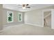 Bright bedroom with carpet and large windows allowing ample natural light and staircase access at 2901 Hunters Bluff Dr, Raleigh, NC 27606