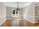 Elegant dining room featuring hardwood floors, decorative molding, and a stylish chandelier fixture at 2901 Hunters Bluff Dr, Raleigh, NC 27606