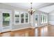 Bright dining room featuring hardwood floors, chandelier, neutral paint, and large windows at 2901 Hunters Bluff Dr, Raleigh, NC 27606