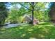 Exterior of a brick house with a two-car garage, a screened porch, and a large yard at 2901 Hunters Bluff Dr, Raleigh, NC 27606