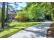 Beautiful two-story brick home with a manicured lawn, lush trees, and a long driveway, creating curb appeal at 2901 Hunters Bluff Dr, Raleigh, NC 27606