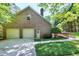 Brick home with a two-car garage, accessible entrance ramp, and lush green landscaping, offering accessibility and charm at 2901 Hunters Bluff Dr, Raleigh, NC 27606