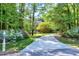 Charming two-story home with a long driveway, surrounded by lush landscaping and mature trees at 2901 Hunters Bluff Dr, Raleigh, NC 27606
