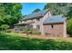 Brick home with a screened porch and well-manicured lawn and landscaping at 2901 Hunters Bluff Dr, Raleigh, NC 27606
