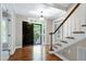 Bright foyer featuring hardwood floors, staircase, and front door at 2901 Hunters Bluff Dr, Raleigh, NC 27606