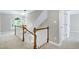 Bright upstairs hallway with decorative railing and natural light at 2901 Hunters Bluff Dr, Raleigh, NC 27606