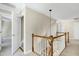 Upstairs hallway with wooden railing, carpet, and doorways leading to other rooms at 2901 Hunters Bluff Dr, Raleigh, NC 27606