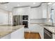 Close-up of the kitchen featuring stainless steel appliances, granite countertops, and white cabinetry at 2901 Hunters Bluff Dr, Raleigh, NC 27606