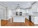 Spacious kitchen with white cabinetry, stainless steel appliances, and a center island with granite countertop at 2901 Hunters Bluff Dr, Raleigh, NC 27606