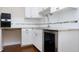 Bright kitchen features white cabinets, granite countertops, tiled backsplash, and stainless steel wine cooler at 2901 Hunters Bluff Dr, Raleigh, NC 27606