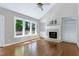 Bright living room with hardwood floors, fireplace, built-in shelving, and vaulted ceiling at 2901 Hunters Bluff Dr, Raleigh, NC 27606