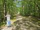 A community walking trail through a canopy of trees, inviting residents for outdoor recreation and exercise at 2901 Hunters Bluff Dr, Raleigh, NC 27606