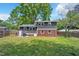 Back exterior view highlights the spacious yard and architectural details of this lovely home at 2904 Falkirk Pl, Raleigh, NC 27604