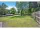 Expansive backyard features lush lawn, mature trees, and a privacy fence, perfect for outdoor enjoyment at 2904 Falkirk Pl, Raleigh, NC 27604