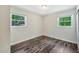 Bedroom featuring vinyl floors and ample natural light from two windows at 2904 Falkirk Pl, Raleigh, NC 27604