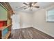 Bedroom featuring a ceiling fan, window, and wood-look laminate flooring at 2904 Falkirk Pl, Raleigh, NC 27604