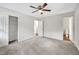 Spacious bedroom with plush carpeting, a ceiling fan, and ample closet space at 2904 Falkirk Pl, Raleigh, NC 27604
