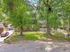 Charming front exterior with covered porch, mature trees, and manicured lawn at 2904 Falkirk Pl, Raleigh, NC 27604