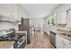Modern kitchen features stainless steel appliances and granite countertops in a bright space at 2904 Falkirk Pl, Raleigh, NC 27604
