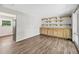 A living area featuring a wood floor and a wooden wall unit with shelves and cabinets at 2904 Falkirk Pl, Raleigh, NC 27604
