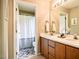 Well-lit bathroom with double sinks and tiled floors at 3 Little Stone Cir, Durham, NC 27703