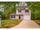 Charming two-story home featuring neutral siding, blue shutters, and a welcoming front door with a decorative wreath at 3 Little Stone Cir, Durham, NC 27703