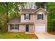 Charming two-story home featuring neutral siding, blue shutters, and a welcoming front door with a decorative wreath at 3 Little Stone Cir, Durham, NC 27703