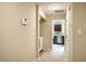 Hallway view into kitchen with stainless steel appliances and in unit laundry area at 3 Little Stone Cir, Durham, NC 27703