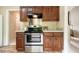 Updated kitchen featuring stainless steel appliances, dark wood cabinets, and durable countertops at 3 Little Stone Cir, Durham, NC 27703