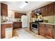 Well-equipped kitchen featuring stainless steel appliances, dark wood cabinets, and durable countertops at 3 Little Stone Cir, Durham, NC 27703