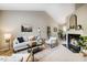 Bright living room featuring high ceilings, a cozy fireplace, modern decor, and an open layout for entertaining at 3 Little Stone Cir, Durham, NC 27703