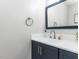 Modern bathroom with navy vanity, white countertop, and stylish faucet at 301 Trappers Sack Rd, Cary, NC 27513