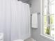 Well-lit bathroom with a shower and window view of the outdoors at 301 Trappers Sack Rd, Cary, NC 27513