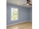 Bedroom with hardwood floors, a window offering natural light, and ceiling fan at 301 Trappers Sack Rd, Cary, NC 27513