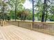 Wooden deck overlooking a lush yard with mature trees at 301 Trappers Sack Rd, Cary, NC 27513