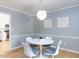 Bright dining area featuring a round table with modern chairs and light fixture at 301 Trappers Sack Rd, Cary, NC 27513