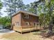 Brick home featuring a wooden deck and complemented by lush landscaping at 301 Trappers Sack Rd, Cary, NC 27513