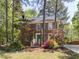 Charming brick home with blue shutters and a well-manicured lawn and garden at 301 Trappers Sack Rd, Cary, NC 27513