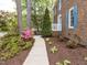 Paver walkway leads to a charming brick home with lush landscaping and a garden at 301 Trappers Sack Rd, Cary, NC 27513