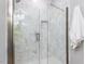 Luxurious marble-tiled shower stall with glass door and built-in niche at 301 Trappers Sack Rd, Cary, NC 27513