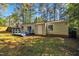 The backyard features a blue-painted wooden deck, home, and privacy fence at 3116 Henslowe Dr, Raleigh, NC 27603
