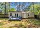 Backyard featuring blue deck, fence, and home with a small window at 3116 Henslowe Dr, Raleigh, NC 27603