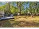 The backyard showcases a wood fence, a small shed, and a blue-painted wooden deck at 3116 Henslowe Dr, Raleigh, NC 27603